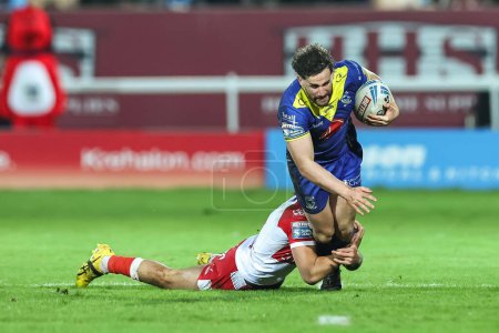 Photo for Toby King of Warrington Wolves is tackled by Tyrone May of Hull KR during the Betfred Super League Round 4 match Hull KR vs Warrington Wolves at Sewell Group Craven Park, Kingston upon Hull, United Kingdom, 7th March 202 - Royalty Free Image