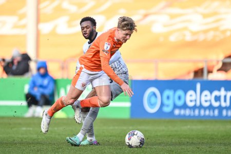 Photo for George Byers of Blackpool rides the challenge of Abu Kamara of Portsmouth during the Sky Bet League 1 match Blackpool vs Portsmouth at Bloomfield Road, Blackpool, United Kingdom, 9th March 202 - Royalty Free Image