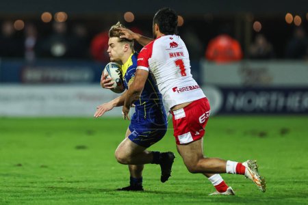 Photo for Leon Hayes of Warrington Wolves is tackled by Peta Hiku of Hull KR during the Betfred Super League Round 4 match Hull KR vs Warrington Wolves at Sewell Group Craven Park, Kingston upon Hull, United Kingdom, 7th March 202 - Royalty Free Image