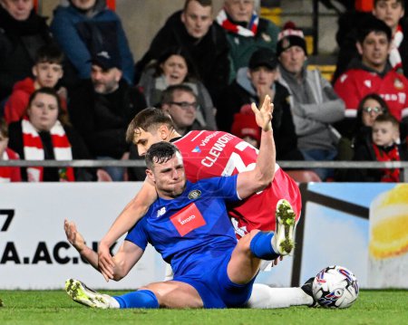 Photo for Max Cleworth of Wrexham fouls Jack Muldoon of Harrogate Town, during the Sky Bet League 2 match Wrexham vs Harrogate Town at SToK Cae Ras, Wrexham, United Kingdom, 12th March 202 - Royalty Free Image