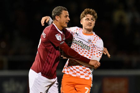 Photo for George Byers of Blackpool and Shaun McWilliams of Northampton Town jossle for position during the Sky Bet League 1 match Northampton Town vs Blackpool at Sixfields Stadium, Northampton, United Kingdom, 12th March 202 - Royalty Free Image