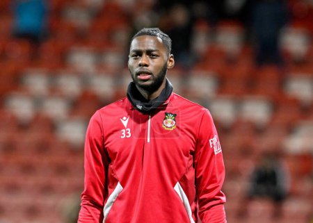 Photo for Arthur Okonkwo of Wrexham warms up ahead of the match, during the Sky Bet League 2 match Wrexham vs Harrogate Town at SToK Cae Ras, Wrexham, United Kingdom, 12th March 202 - Royalty Free Image