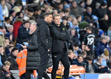 Photo for Eddie Howe manager of Newcastle United speaks with Jason Tindall assistant manager of Newcastle United during the Emirates FA Cup Quarter- Final match Manchester City vs Newcastle United at Etihad Stadium, Manchester, United Kingdom, 16th March 202 - Royalty Free Image