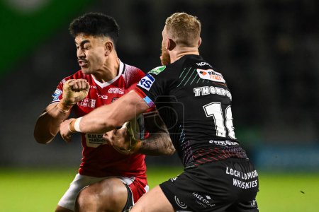 Photo for Tim Lafai of Salford Red Devils is tackled by Luke Thompson of Wigan Warriors during the Betfred Super League Round 5 match Salford Red Devils vs Wigan Warriors at Salford Community Stadium, Eccles, United Kingdom, 14th March 202 - Royalty Free Image