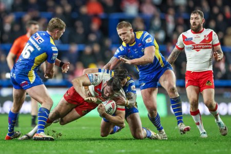 Photo for Alex Walmsley of St. Helens is tackled by James McDonnell of Leeds Rhinos and Andy Ackers of Leeds Rhinos during the Betfred Super League Round 5 match Leeds Rhinos vs St Helens at Headingley Stadium, Leeds, United Kingdom, 15th March 202 - Royalty Free Image