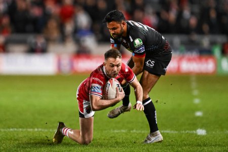 Photo for Ryan Brierley of Salford Red Devils is tackled by Bevan French of Wigan Warriors during the Betfred Super League Round 5 match Salford Red Devils vs Wigan Warriors at Salford Community Stadium, Eccles, United Kingdom, 14th March 202 - Royalty Free Image