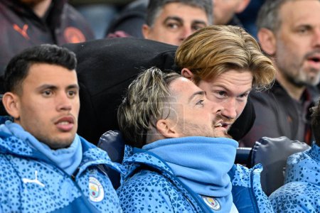 Photo for Jack Grealish of Manchester City speaks with Kevin De Bruyne of Manchester City while on the bench ahead of kick off, during the Emirates FA Cup Quarter- Final match Manchester City vs Newcastle United at Etihad Stadium, Manchester, United Kingdom, 1 - Royalty Free Image