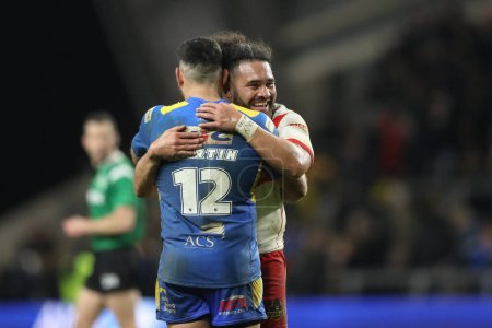 Photo for Konrad Hurrell of St. Helens embraces Rhyse Martin of Leeds Rhinos after the game during the Betfred Super League Round 5 match Leeds Rhinos vs St Helens at Headingley Stadium, Leeds, United Kingdom, 15th March 202 - Royalty Free Image