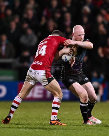 Photo for Liam Farrell of Wigan Warriors is tackled by Chris Atkin of Salford Red Devils during the Betfred Super League Round 5 match Salford Red Devils vs Wigan Warriors at Salford Community Stadium, Eccles, United Kingdom, 14th March 202 - Royalty Free Image