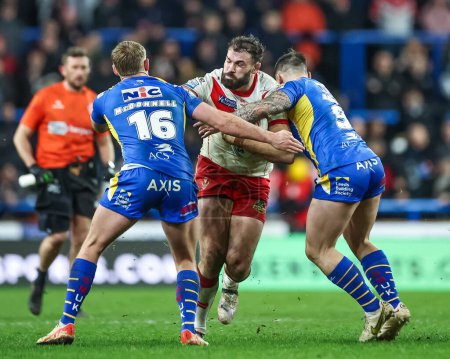 Photo for Alex Walmsley of St. Helens is tackled by James McDonnell of Leeds Rhinos and Andy Ackers of Leeds Rhinos during the Betfred Super League Round 5 match Leeds Rhinos vs St Helens at Headingley Stadium, Leeds, United Kingdom, 15th March 202 - Royalty Free Image