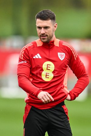 Photo for Aaron Ramsey of Wales during warms up ahead of the Wales open training session at Vale Resort Training complex, Hensol, United Kingdom, 20th March 2024 - Royalty Free Image