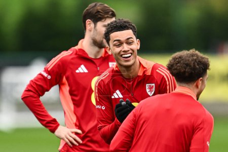 Photo for Brennan Johnson of Wales has a laugh during warms up ahead of the Wales open training session at Vale Resort Training complex, Hensol, United Kingdom, 20th March 2024 - Royalty Free Image