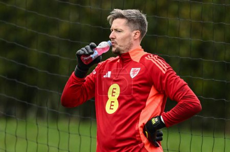Photo for Wayne Hennessey of Wales takes a drink during warms up ahead of the Wales open training session at Vale Resort Training complex, Hensol, United Kingdom, 20th March 2024 - Royalty Free Image