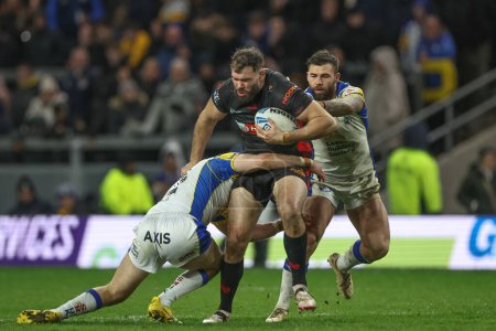 Photo for Alex Walmsley of St. Helens is tackled by Cameron Smith of Leeds Rhinos and Andy Ackers of Leeds Rhinos during the Betfred Challenge Cup Sixth Round match Leeds Rhinos vs St Helens at Headingley Stadium, Leeds, United Kingdom, 22nd March 202 - Royalty Free Image