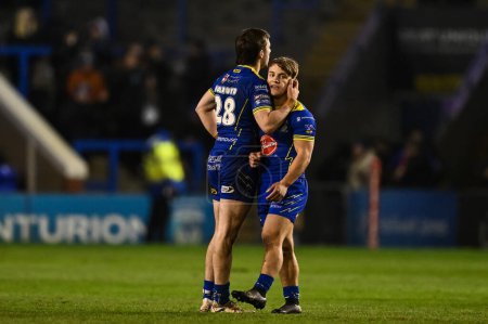 Photo for Adam Holroyd of Warrington Wolves and Leon Hayes of Warrington Wolves celebrate at the end of the Betfred Challenge Cup Sixth Round match Warrington Wolves vs London Broncos at Halliwell Jones Stadium, Warrington, United Kingdom, 23rd March 202 - Royalty Free Image