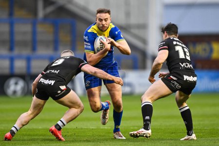 Photo for James Harrison of Warrington Wolves is tackled by Sam Davis of London Broncos during the Betfred Challenge Cup Sixth Round match Warrington Wolves vs London Broncos at Halliwell Jones Stadium, Warrington, United Kingdom, 23rd March 202 - Royalty Free Image