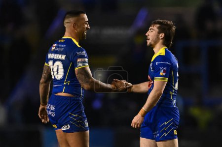 Photo for Paul Vaughan of Warrington Wolves and Adam Holroyd of Warrington Wolves shake hands at the end of the the Betfred Challenge Cup Sixth Round match Warrington Wolves vs London Broncos at Halliwell Jones Stadium, Warrington, United Kingdom, 23rd March 2 - Royalty Free Image