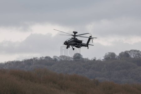 Photo for British Army's Final Flight of Apache Mk.1 from Chepstow to Monmouth today as part of the Farewell Fly Past marking the end of the D variant in the UK Wye Valley, Chepstow, United Kingdom, 26th March 202 - Royalty Free Image