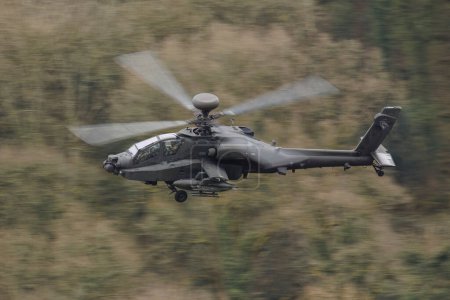 Photo for British Army's Final Flight of Apache Mk.1 from Chepstow to Monmouth today as part of the Farewell Fly Past marking the end of the D variant in the UK Wye Valley, Chepstow, United Kingdom, 26th March 202 - Royalty Free Image
