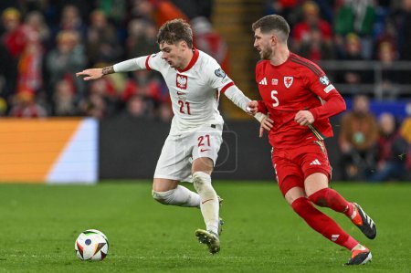 Photo for Nicola Zalewski of Poland holds off Chris Mepham of Wales during the UEFA Euro Qualifiers Eliminator Group A match Wales vs Poland at Cardiff City Stadium, Cardiff, United Kingdom, 26th March 202 - Royalty Free Image