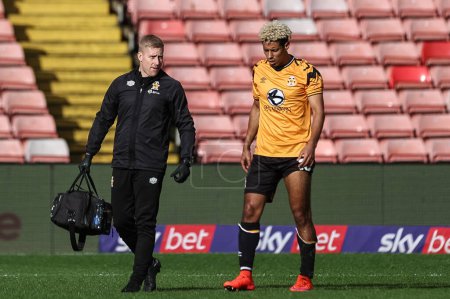 Photo for Lyle Taylor of Cambridge United leaves the field injured during the Sky Bet League 1 match Barnsley vs Cambridge United at Oakwell, Barnsley, United Kingdom, 29th March 202 - Royalty Free Image