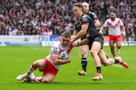 Photo for Lewis Dodd of St. Helens is tackled by Jai Field of Wigan Warriors  during the Betfred Super League Round 6 match St Helens vs Wigan Warriors at Totally Wicked Stadium, St Helens, United Kingdom, 29th March 202 - Royalty Free Image