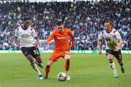 Photo for Sonny Carey of Blackpool goes forward with the ball during the Sky Bet League 1 match Derby County vs Blackpool at Pride Park Stadium, Derby, United Kingdom, 29th March 202 - Royalty Free Image