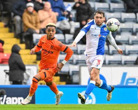 Photo for Omari Hutchinson  of Ipswich Town and Harry Pickering of Blackburn Rovers chases down the ball, during the Sky Bet Championship match Blackburn Rovers vs Ipswich Town at Ewood Park, Blackburn, United Kingdom, 29th March 202 - Royalty Free Image