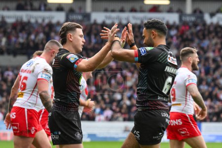 Photo for Jai Field of Wigan Warriors and Bevan French of Wigan Warriors celebrate the turnover during the Betfred Super League Round 6 match St Helens vs Wigan Warriors at Totally Wicked Stadium, St Helens, United Kingdom, 29th March 202 - Royalty Free Image