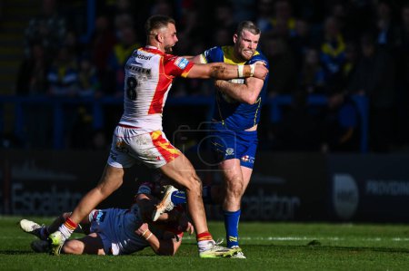 Photo for Lachlan Fitzgibbon of Warrington Wolves breaks free from the tackle of Ugo Tison of Catalan Dragons and Mike McMeeken of Catalan Dragons during the Betfred Super League match Warrington Wolves vs Catalans Dragons at Halliwell Jones Stadium, Warringto - Royalty Free Image