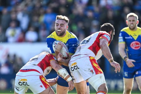 Photo for James Harrison of Warrington Wolves is tackled by Ben Garcia of Catalan Dragons and Julian Bousquet of Catalan Dragons during the Betfred Super League match Warrington Wolves vs Catalans Dragons at Halliwell Jones Stadium, Warrington, United Kingdom, - Royalty Free Image