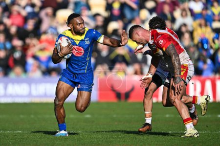 Photo for Rodrick Tai of Warrington Wolves fends off Tariq Sims of Catalan Dragons during the Betfred Super League match Warrington Wolves vs Catalans Dragons at Halliwell Jones Stadium, Warrington, United Kingdom, 30th March 202 - Royalty Free Image