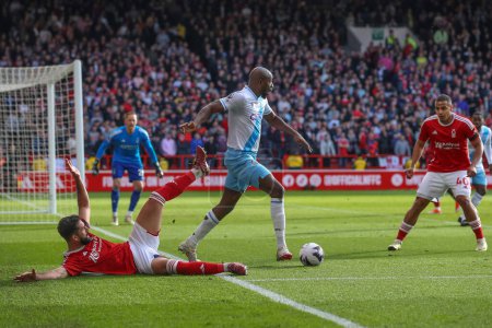 Photo for Jean-Philippe Mateta of Crystal Palace tackles Felipe of Nottingham Forest during the Premier League match Nottingham Forest vs Crystal Palace at City Ground, Nottingham, United Kingdom, 30th March 202 - Royalty Free Image