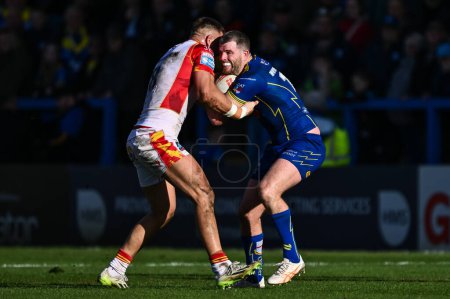 Photo for Lachlan Fitzgibbon of Warrington Wolves is tackled by  Mike McMeeken of Catalan Dragons during the Betfred Super League match Warrington Wolves vs Catalans Dragons at Halliwell Jones Stadium, Warrington, United Kingdom, 30th March 202 - Royalty Free Image