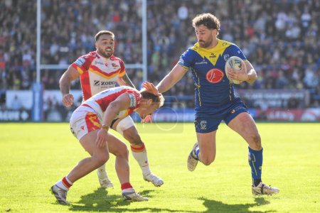 Photo for Toby King of Warrington Wolves fends off Ugo Tison of Catalan Dragons during the Betfred Super League match Warrington Wolves vs Catalans Dragons at Halliwell Jones Stadium, Warrington, United Kingdom, 30th March 202 - Royalty Free Image