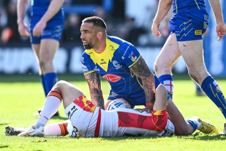 Photo for Cesar Rouge of Catalan Dragons is tackled by Paul Vaughan of Warrington Wolves  during the Betfred Super League match Warrington Wolves vs Catalans Dragons at Halliwell Jones Stadium, Warrington, United Kingdom, 30th March 202 - Royalty Free Image