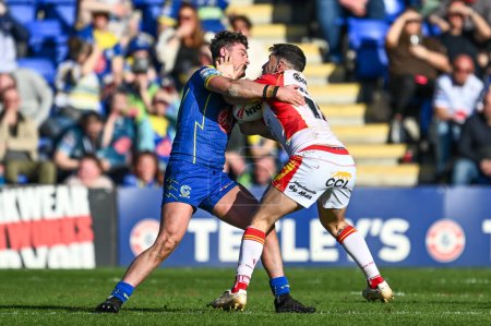 Photo for Ben Garcia of Catalan Dragons is tackled by Jordan Crowther of Warrington Wolves during the Betfred Super League match Warrington Wolves vs Catalans Dragons at Halliwell Jones Stadium, Warrington, United Kingdom, 30th March 202 - Royalty Free Image