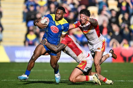 Photo for Rodrick Tai of Warrington Wolves is tackled by Tariq Sims of Catalan Dragons during the Betfred Super League match Warrington Wolves vs Catalans Dragons at Halliwell Jones Stadium, Warrington, United Kingdom, 30th March 202 - Royalty Free Image