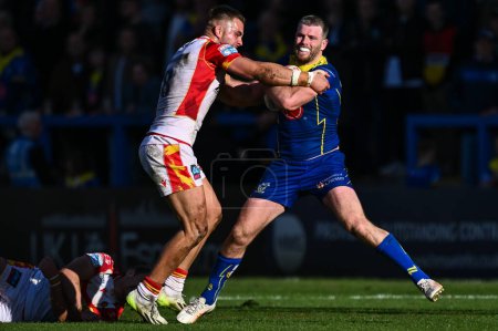 Photo for Lachlan Fitzgibbon of Warrington Wolves breaks free from the tackle of Ugo Tison of Catalan Dragons and Mike McMeeken of Catalan Dragons during the Betfred Super League match Warrington Wolves vs Catalans Dragons at Halliwell Jones Stadium, Warringto - Royalty Free Image