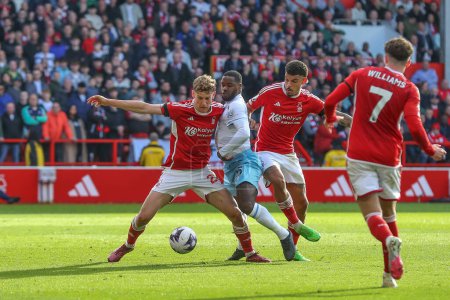 Photo for Ryan Yates of Nottingham Forest and Jeffrey Schlupp of Crystal Palace battle for the ball during the Premier League match Nottingham Forest vs Crystal Palace at City Ground, Nottingham, United Kingdom, 30th March 202 - Royalty Free Image