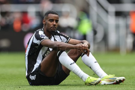 Photo for Alexander Isak of Newcastle United sits on the pitch after the final whistle as Newcastle come back to win 4-3 during the Premier League match Newcastle United vs West Ham United at St. James's Park, Newcastle, United Kingdom, 30th March 202 - Royalty Free Image