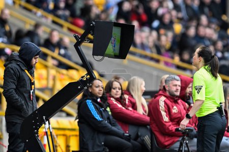 Photo for Referee Cheryl Foster checks the VAR screen during the FA Women's League Cup Final match Arsenal Women vs Chelsea FC Women at Molineux, Wolverhampton, United Kingdom, 31st March 202 - Royalty Free Image
