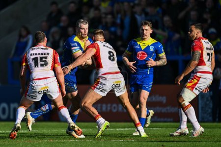 Photo for Lachlan Fitzgibbon of Warrington Wolves is tackled by Mike McMeeken of Catalan Dragons during the Betfred Super League match Warrington Wolves vs Catalans Dragons at Halliwell Jones Stadium, Warrington, United Kingdom, 30th March 202 - Royalty Free Image