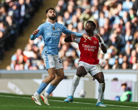 Photo for Joko Gvardiol of Manchester City and Bukayo Saka of Arsenal battle for positionduring the Premier League match Manchester City vs Arsenal at Etihad Stadium, Manchester, United Kingdom, 31st March 2024 - Royalty Free Image