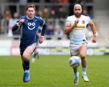 Photo for Tom Roebuck of Sale Sharks and Olly Woodburn of Exeter Chiefs chase a loose ball during the Gallagher Premiership match Sale Sharks vs Exeter Chiefs at Salford Community Stadium, Eccles, United Kingdom, 31st March 202 - Royalty Free Image