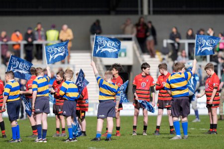 Photo for Young Sale fans wave Sharks flags before the Gallagher Premiership match Sale Sharks vs Exeter Chiefs at Salford Community Stadium, Eccles, United Kingdom, 31st March 202 - Royalty Free Image
