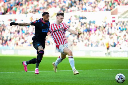 Photo for Luke McNally of Stoke City denies Delano Burgzorg of Huddersfield Town a chance on goal during the Sky Bet Championship match Stoke City vs Huddersfield Town at Bet365 Stadium, Stoke-on-Trent, United Kingdom, 1st April 202 - Royalty Free Image