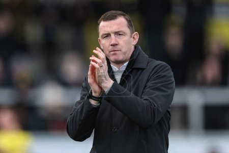 Photo for Neill Collins Head coach of Barnsley applauds the traveling fans bmduring the Sky Bet League 1 match Burton Albion vs Barnsley at Pirelli Stadium, Burton upon Trent, United Kingdom, 1st April 202 - Royalty Free Image