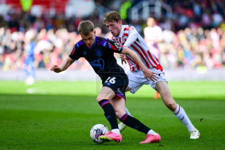 Photo for Wouter Burger of Stoke City hunts down Pat Jones of Huddersfield Town during the Sky Bet Championship match Stoke City vs Huddersfield Town at Bet365 Stadium, Stoke-on-Trent, United Kingdom, 1st April 202 - Royalty Free Image