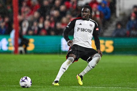 Photo for Calvin Bassey of Fulham passes the ballduring the Premier League match Nottingham Forest vs Fulham at City Ground, Nottingham, United Kingdom, 2nd April 202 - Royalty Free Image